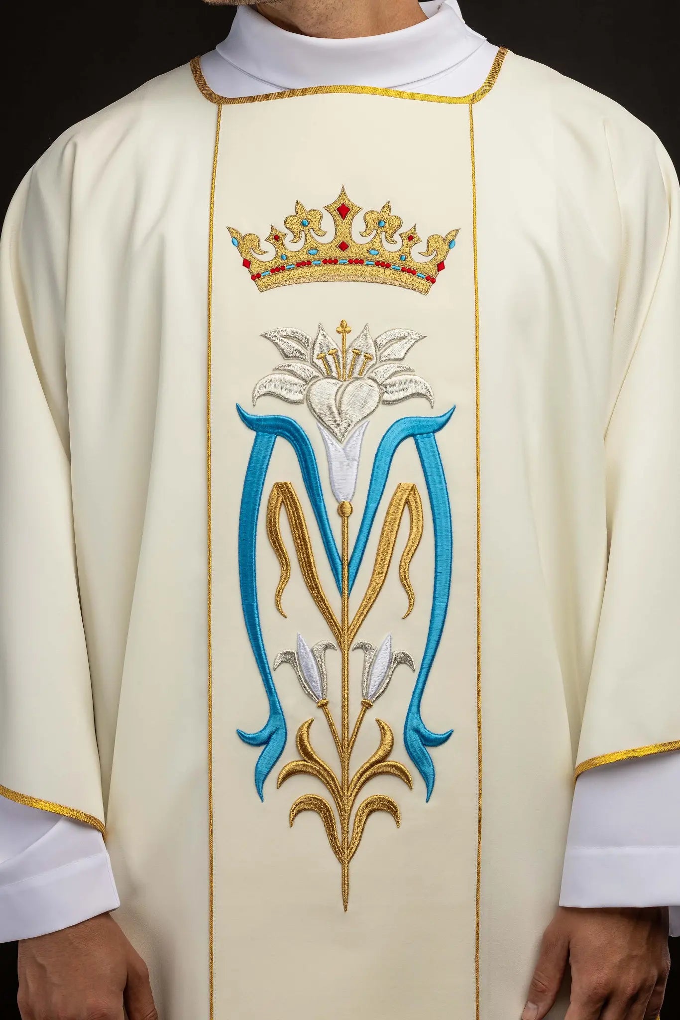 Ecru dalmatic with Marian embroidery, gold trim, and a matching stole.
