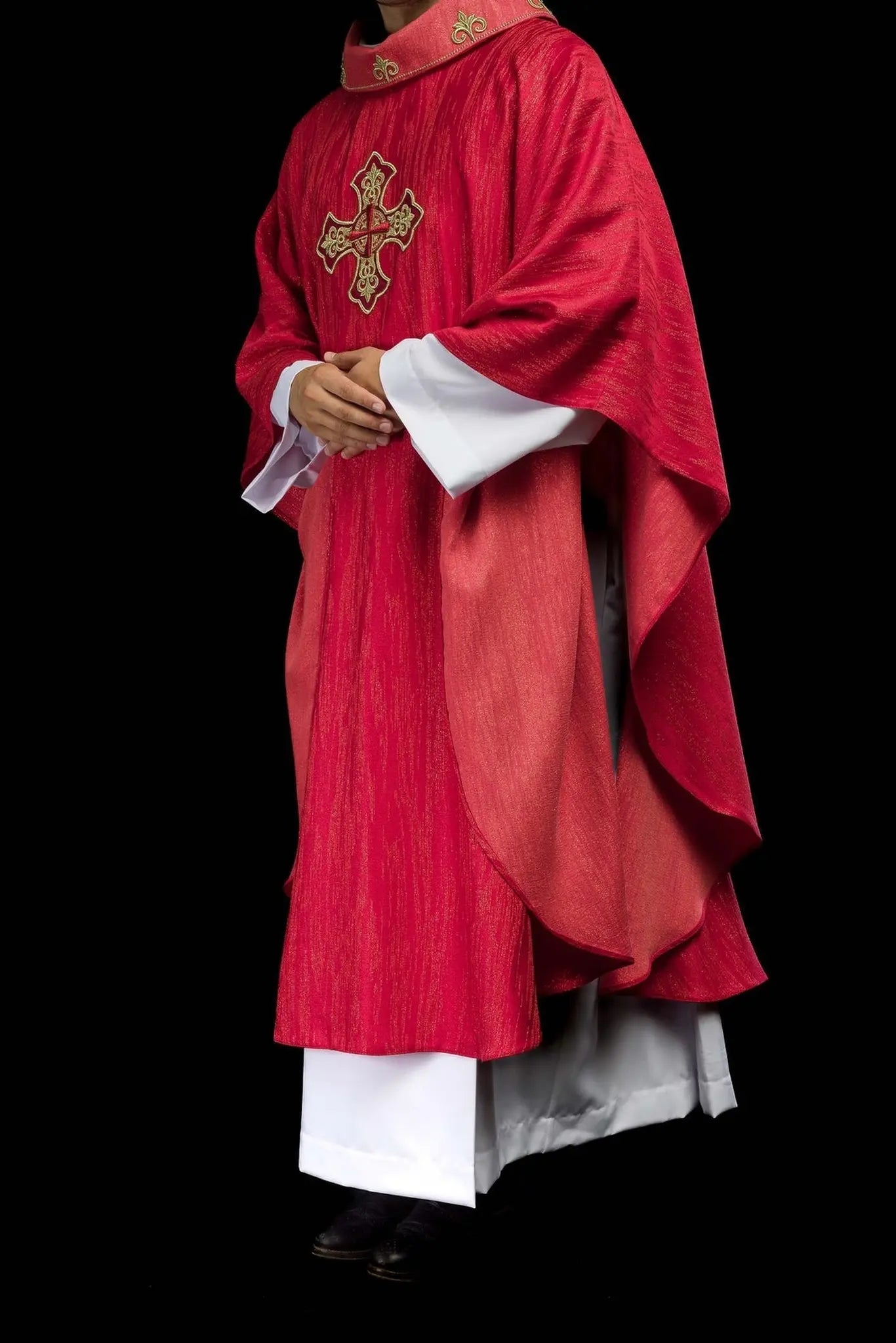 Red chasuble with embroidered cross motif on decorative fabric