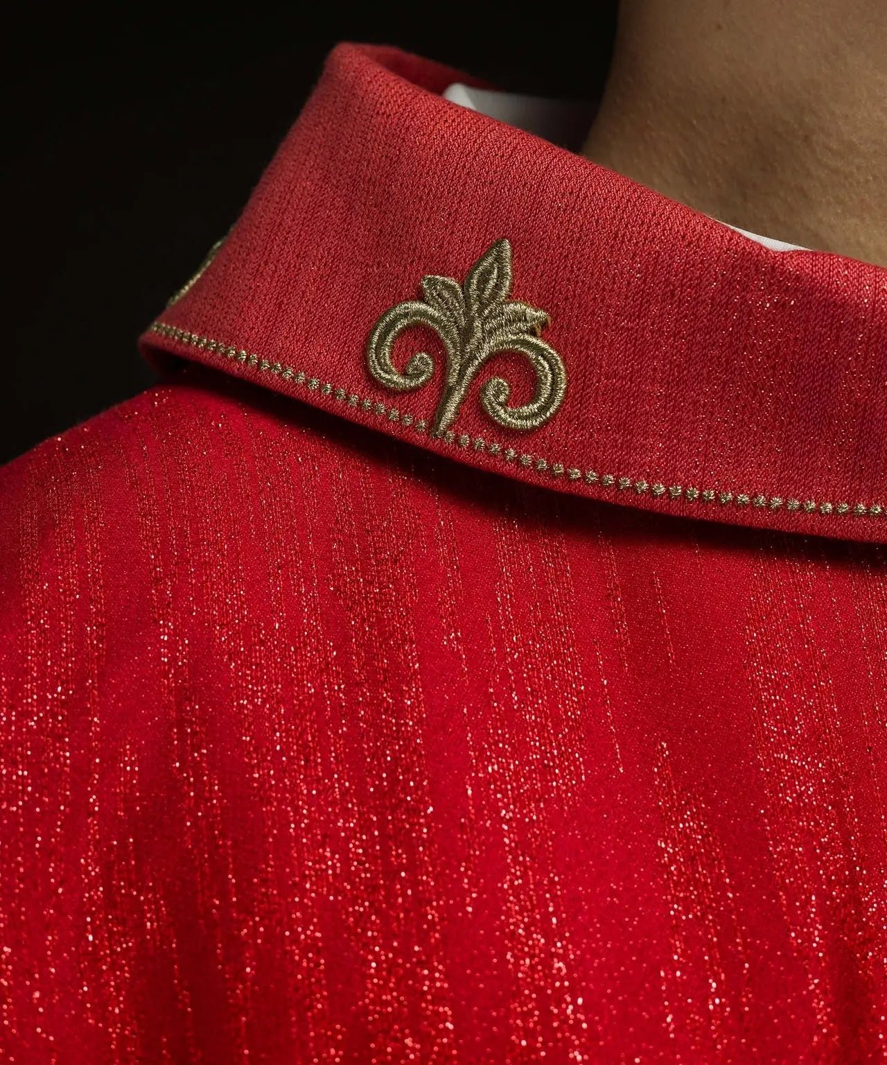 Red chasuble with embroidered cross motif on decorative fabric