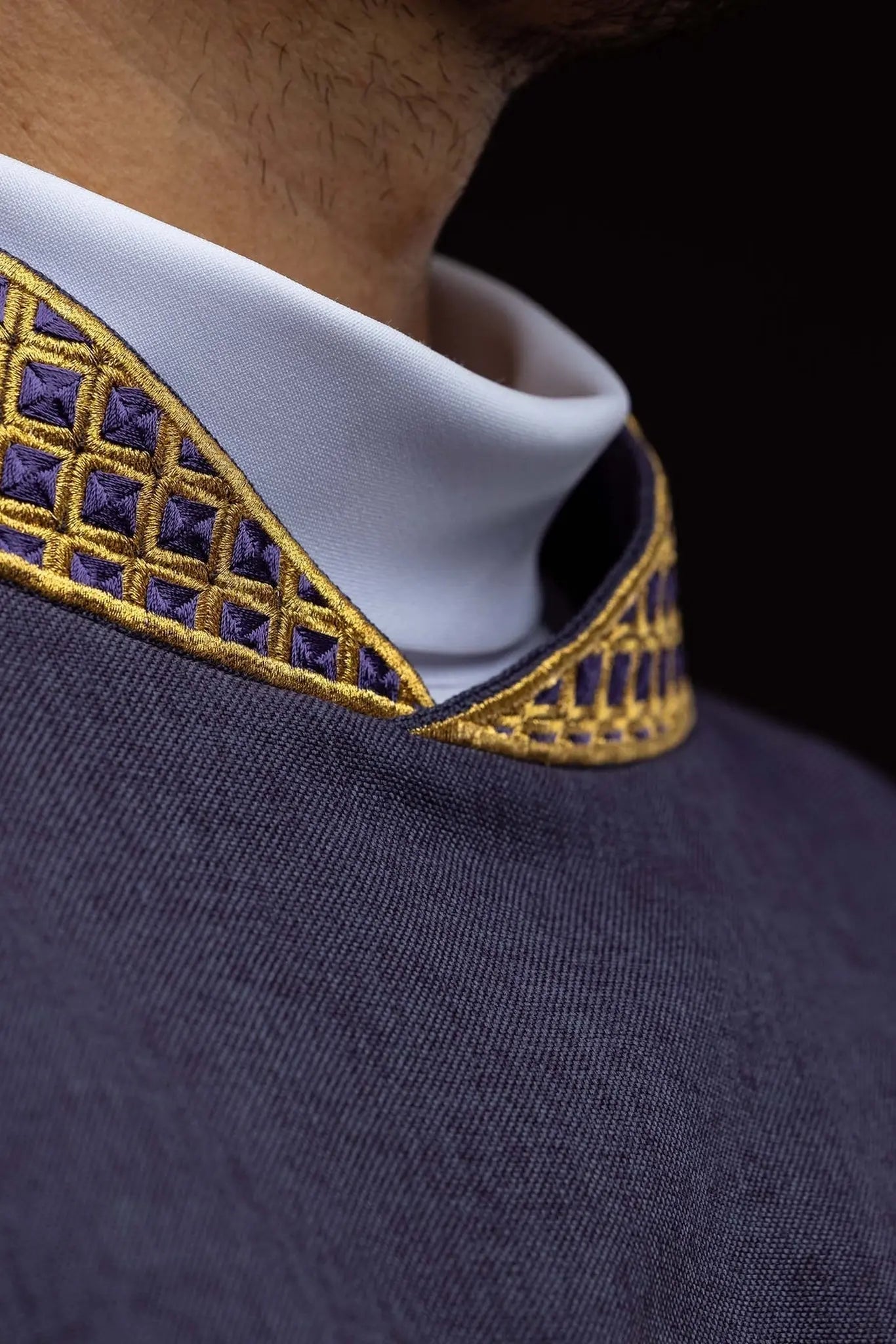 Purple dalmatic with embroidered crosses and collar