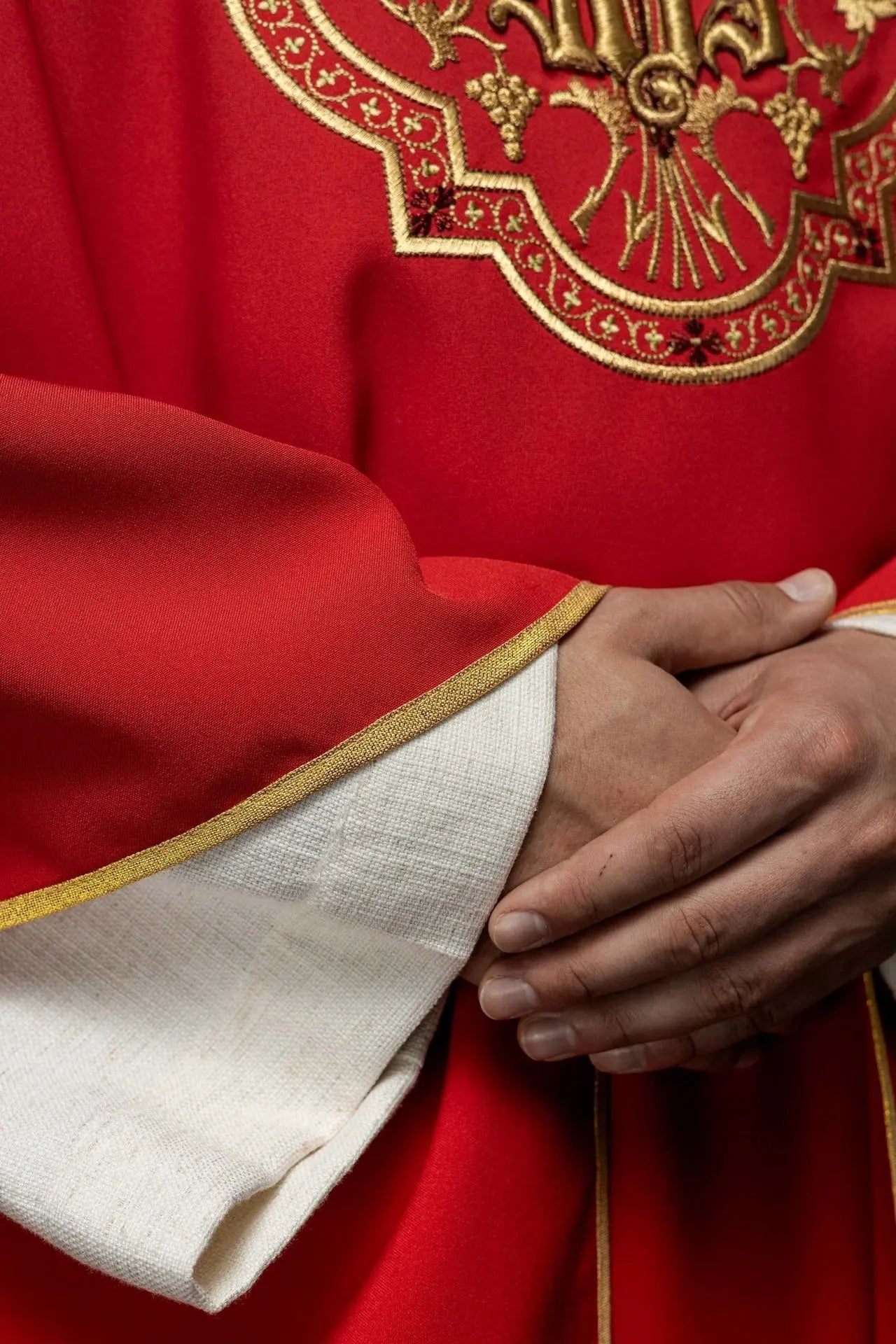Red chasuble with IHS and PAX embroidery