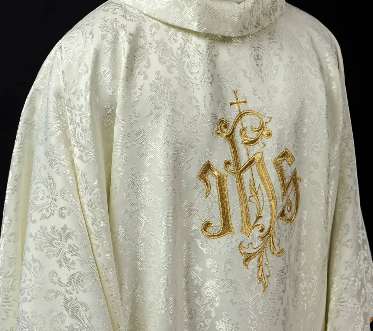 Ecru chasuble with embroidered IHS motif on decorative fabric