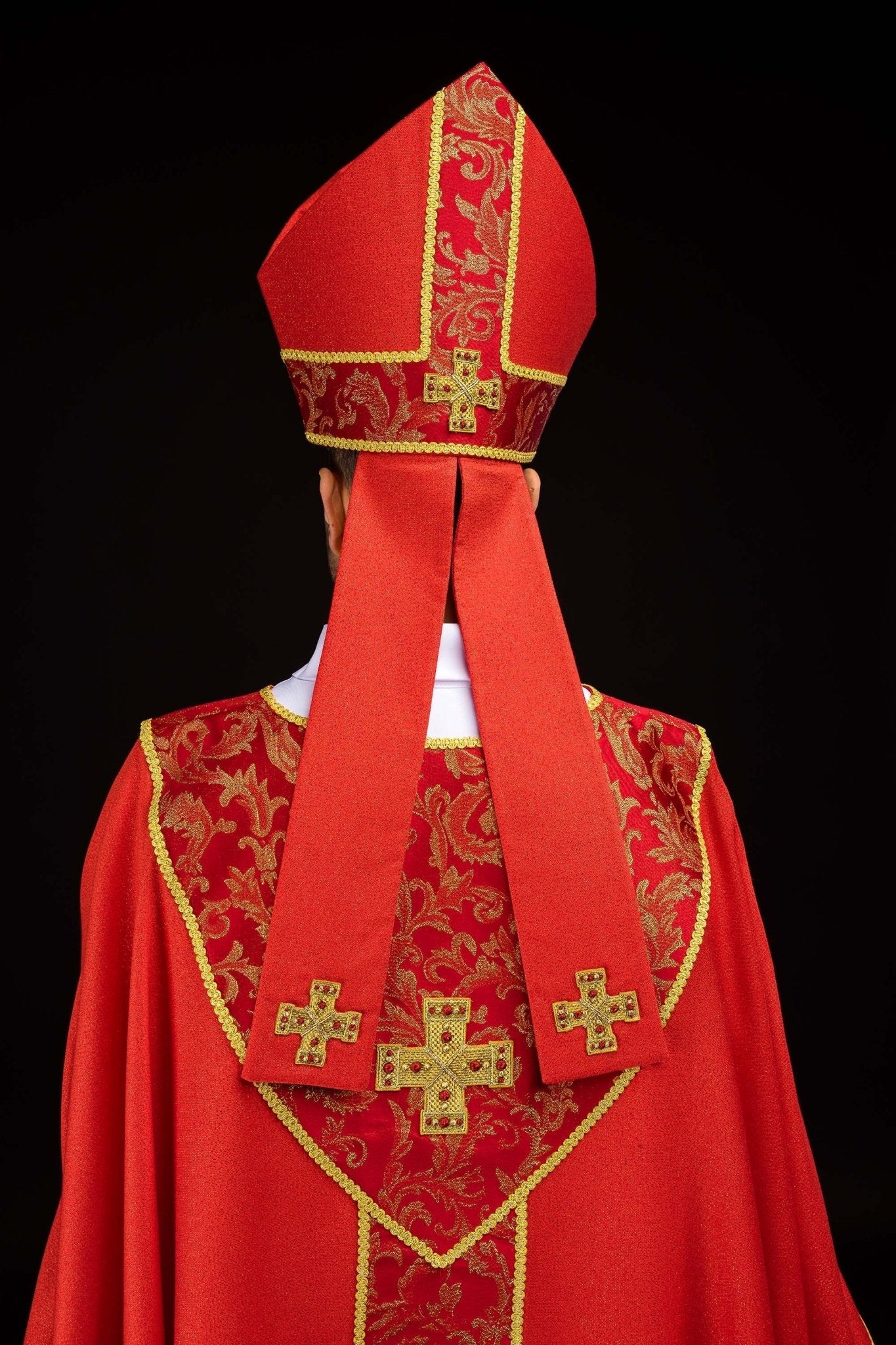 Red embroidered mitre with a cross motif and decorative jacquard fabric