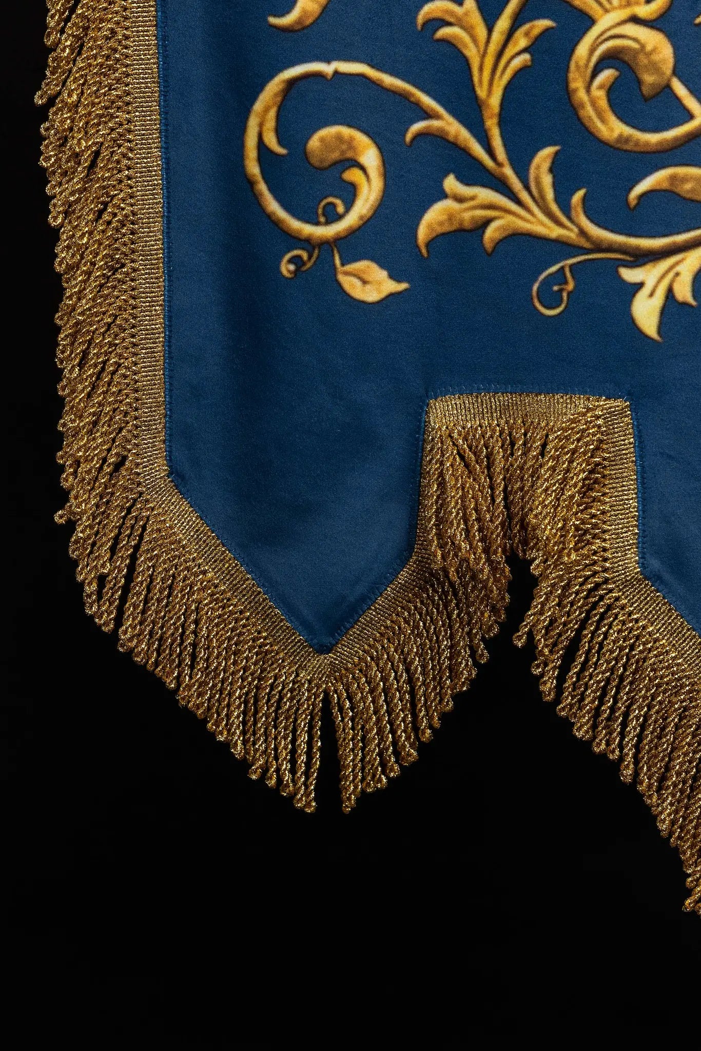 Double-sided blue processional banner with an image of Our Lady of the Immaculate Conception on one side and a Marian monogram on the other, both surrounded by gold floral ornamentation and finished with gold fringes.