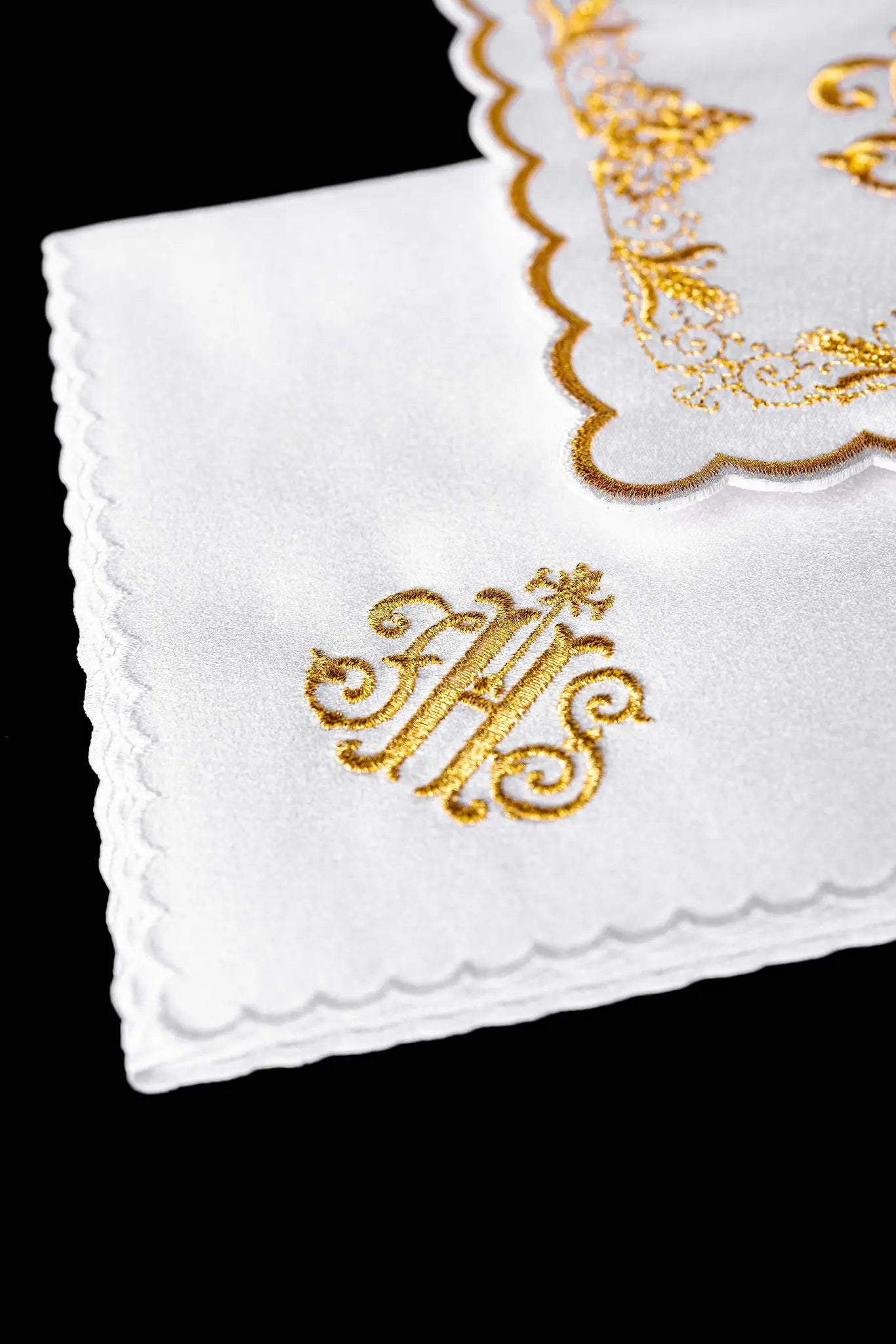 White chalice linen set with IHS embroidery on pall, purificator, and lavabo towel.