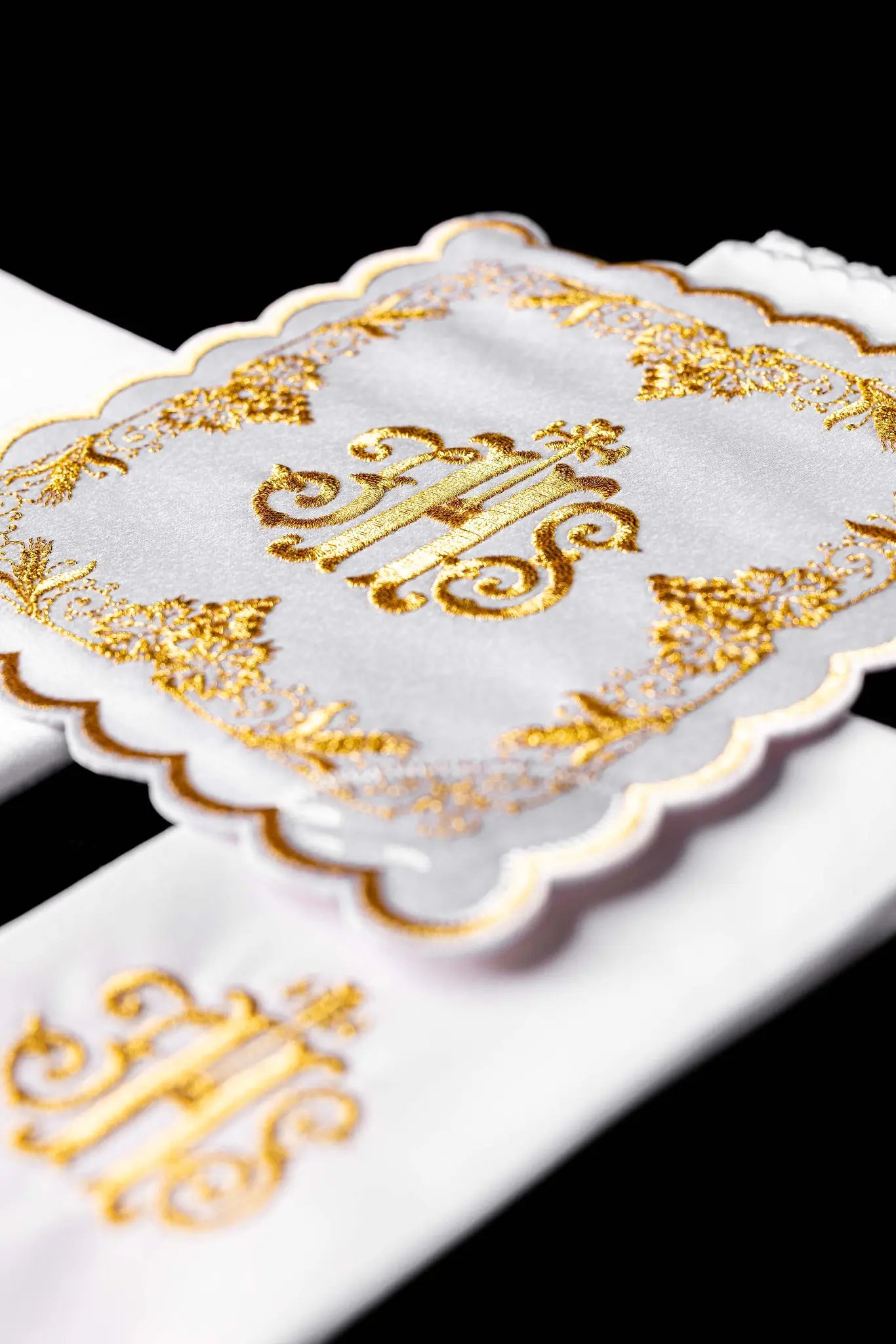 White chalice linen set with IHS embroidery on pall, purificator, and lavabo towel.