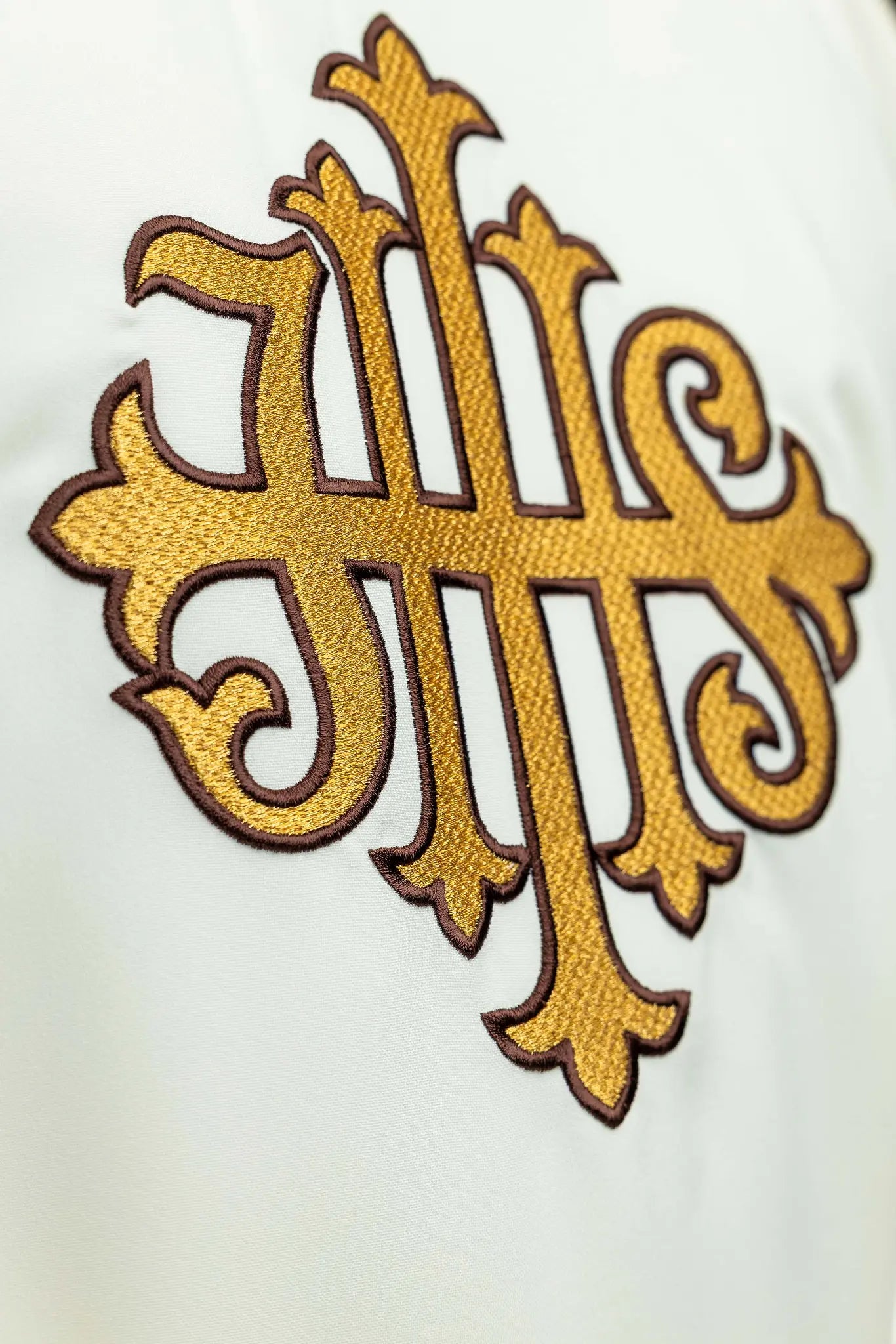 Ecru chasuble with gold IHS embroidery and gold trim, featuring a V-neck collar.