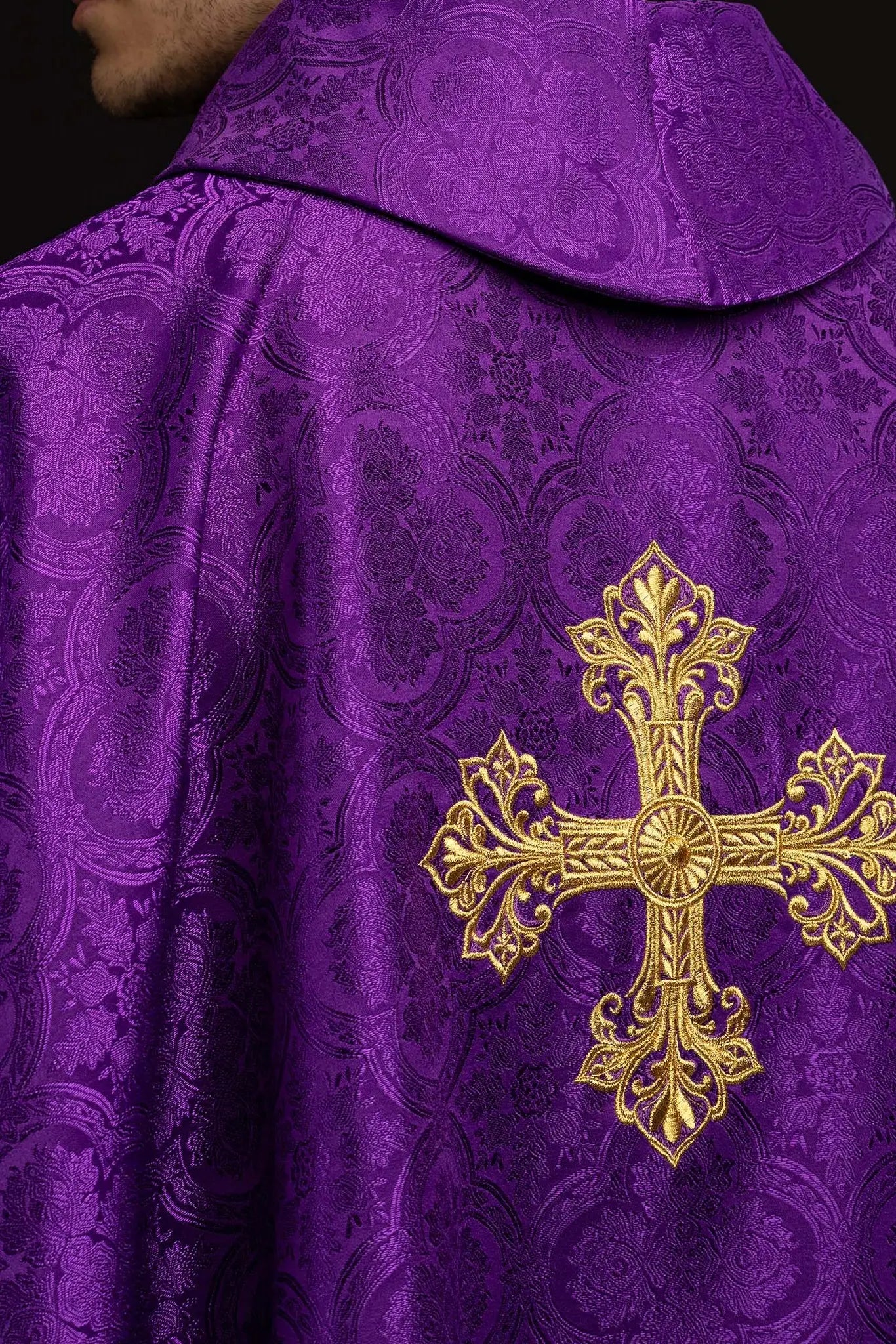 Purple chasuble with a gold embroidered cross on jacquard fabric, featuring a stand-up collar and gold trim.