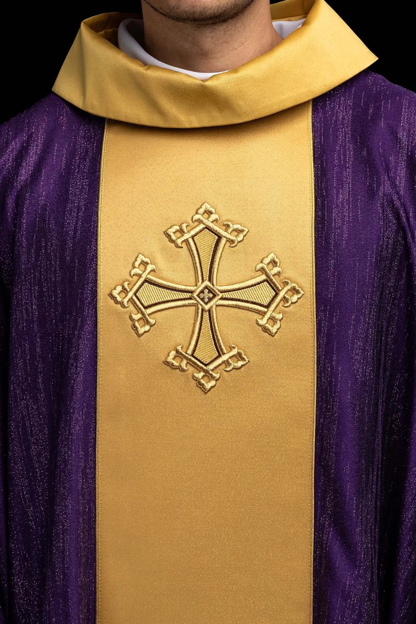 Purple chasuble with a vertical gold band featuring embroidered stylized crosses, gold trim on sleeves and collar, and a stand-up collar.