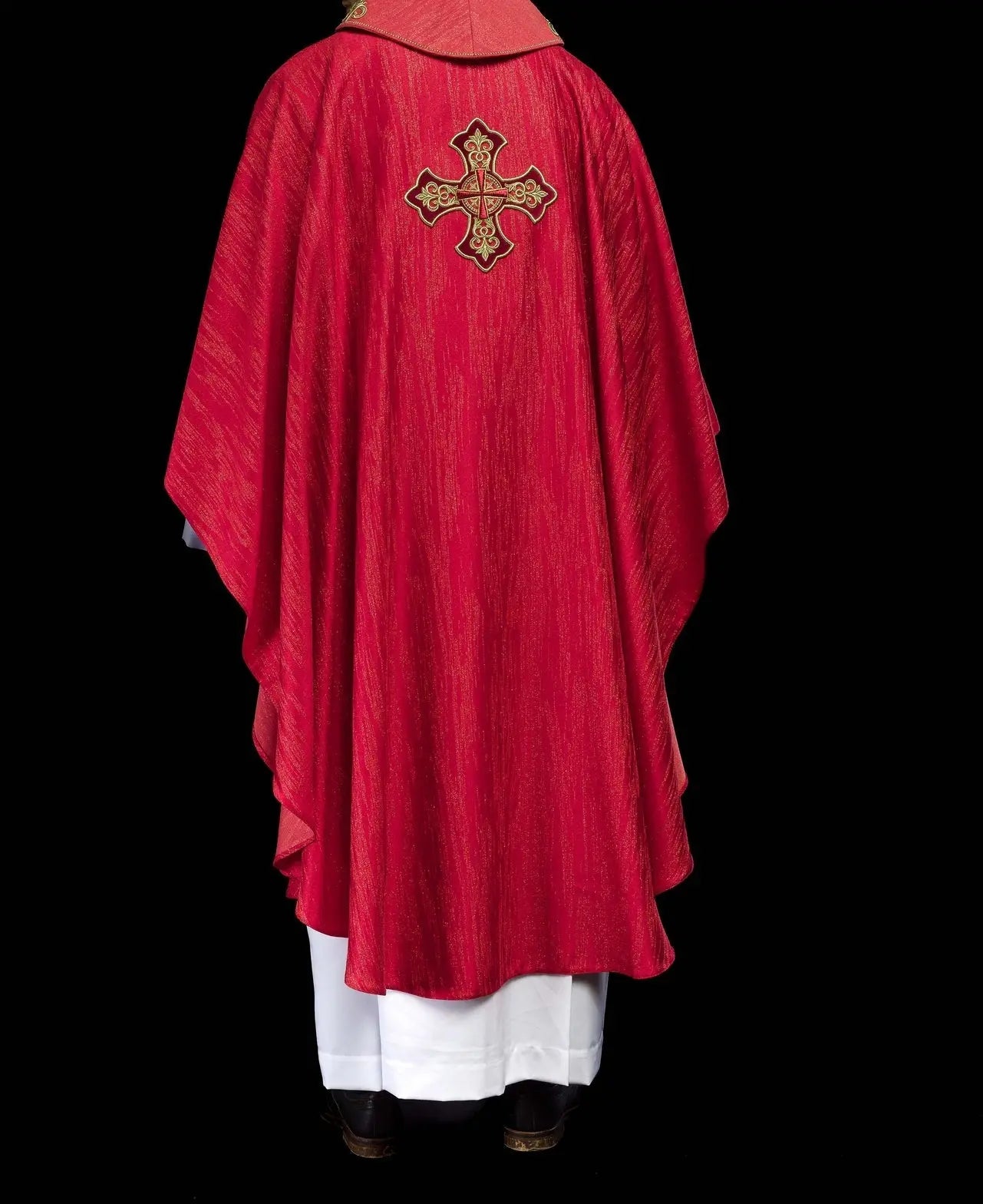 Red chasuble with embroidered cross motif on decorative fabric