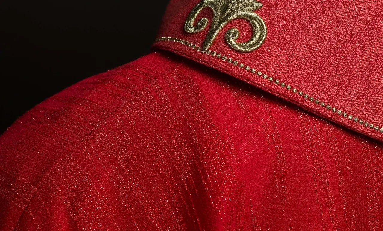 Red chasuble with embroidered cross motif on decorative fabric