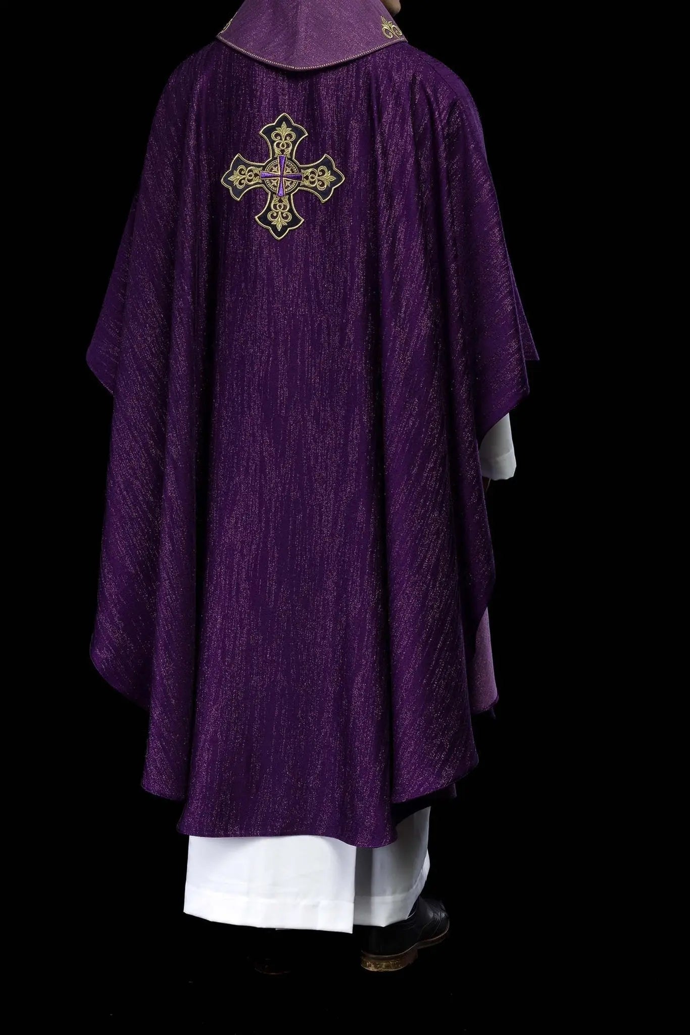 Purple chasuble with embroidered cross motif on decorative fabric