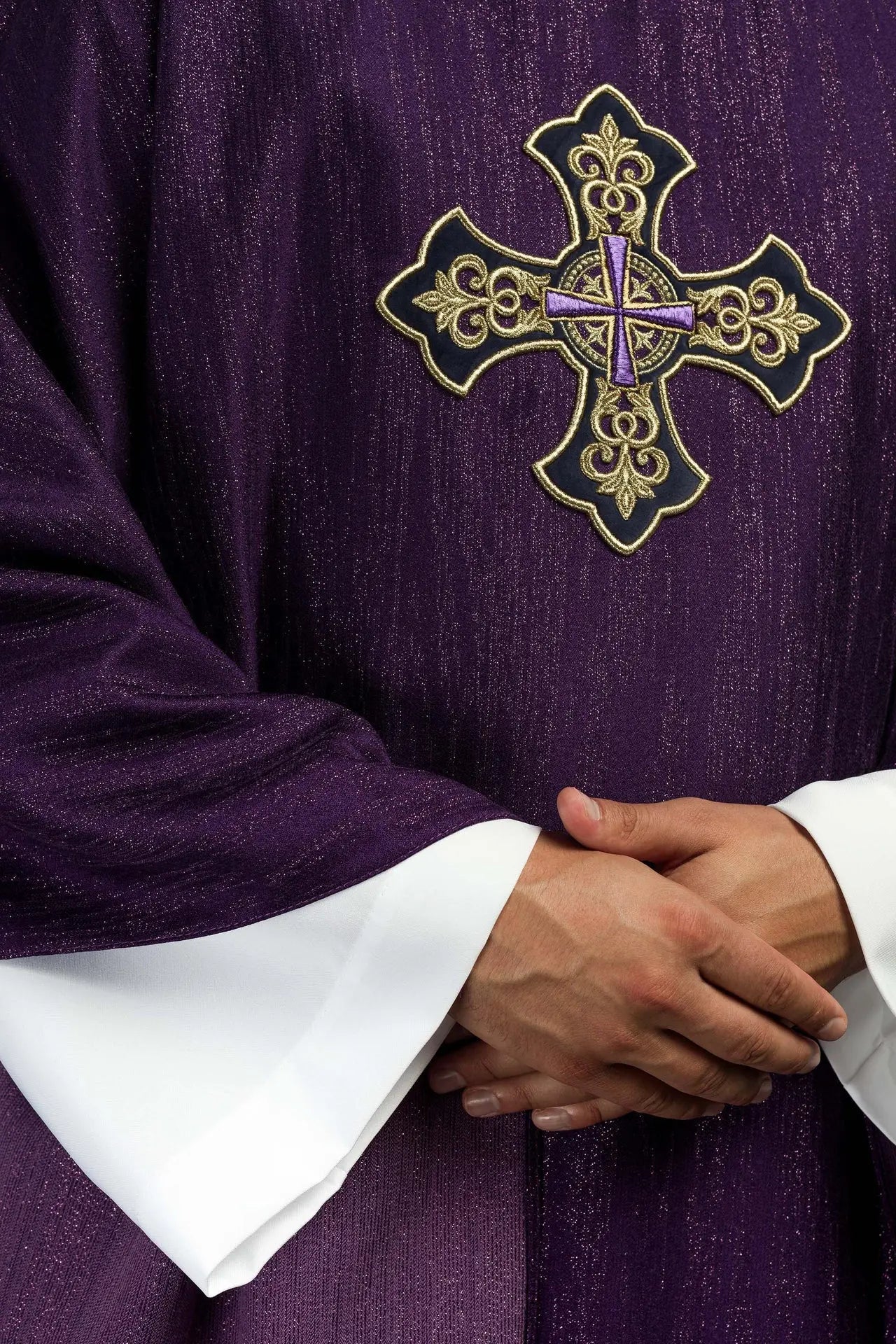 Purple chasuble with embroidered cross motif on decorative fabric