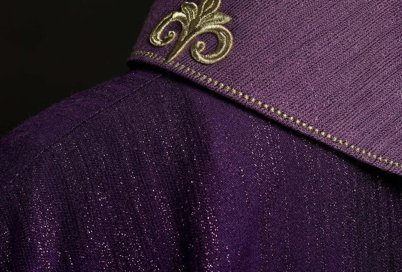 Purple chasuble with embroidered cross motif on decorative fabric