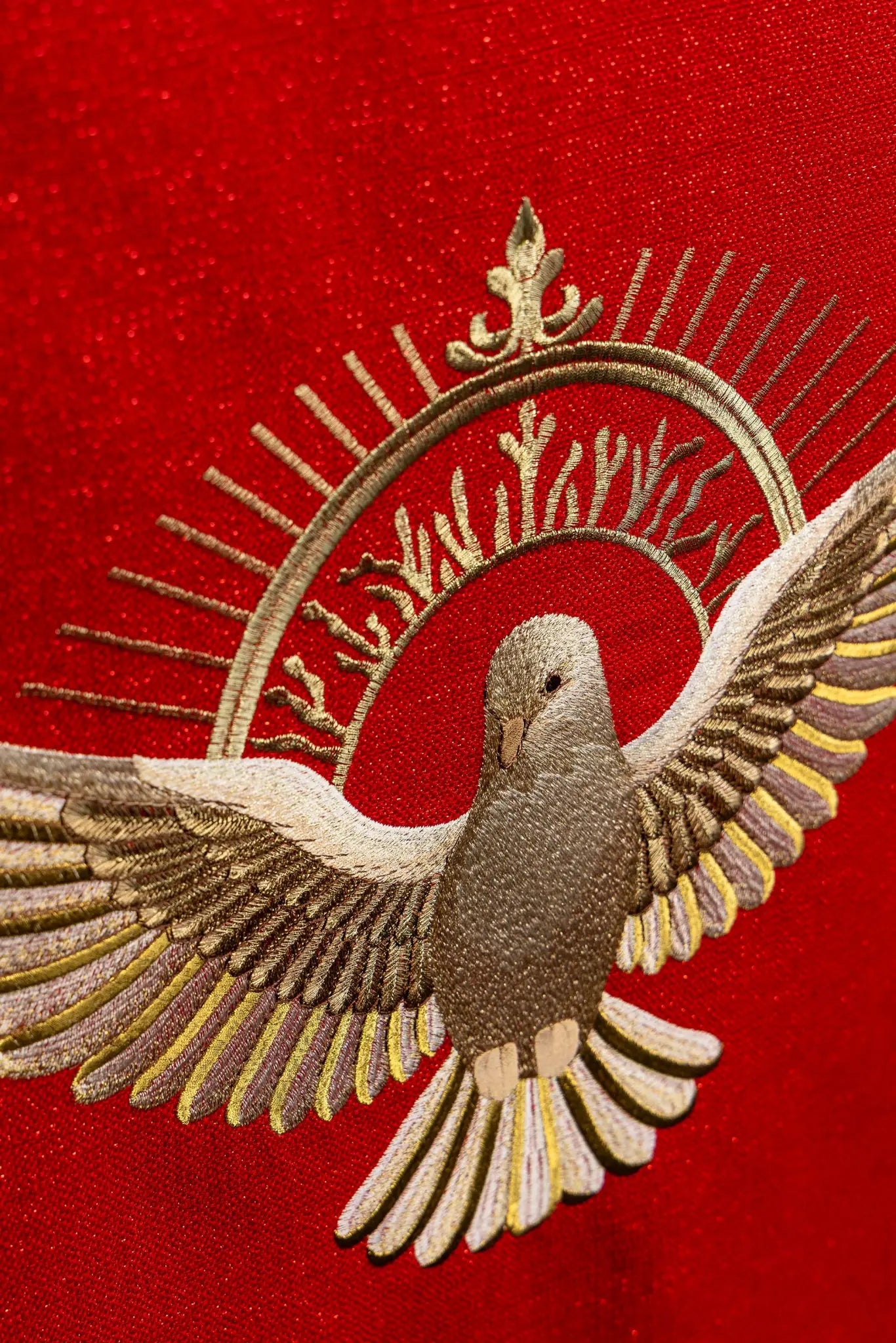 Red lectern hanging with embroidered Dove of the Holy Spirit and rays, finished with gold fringes.