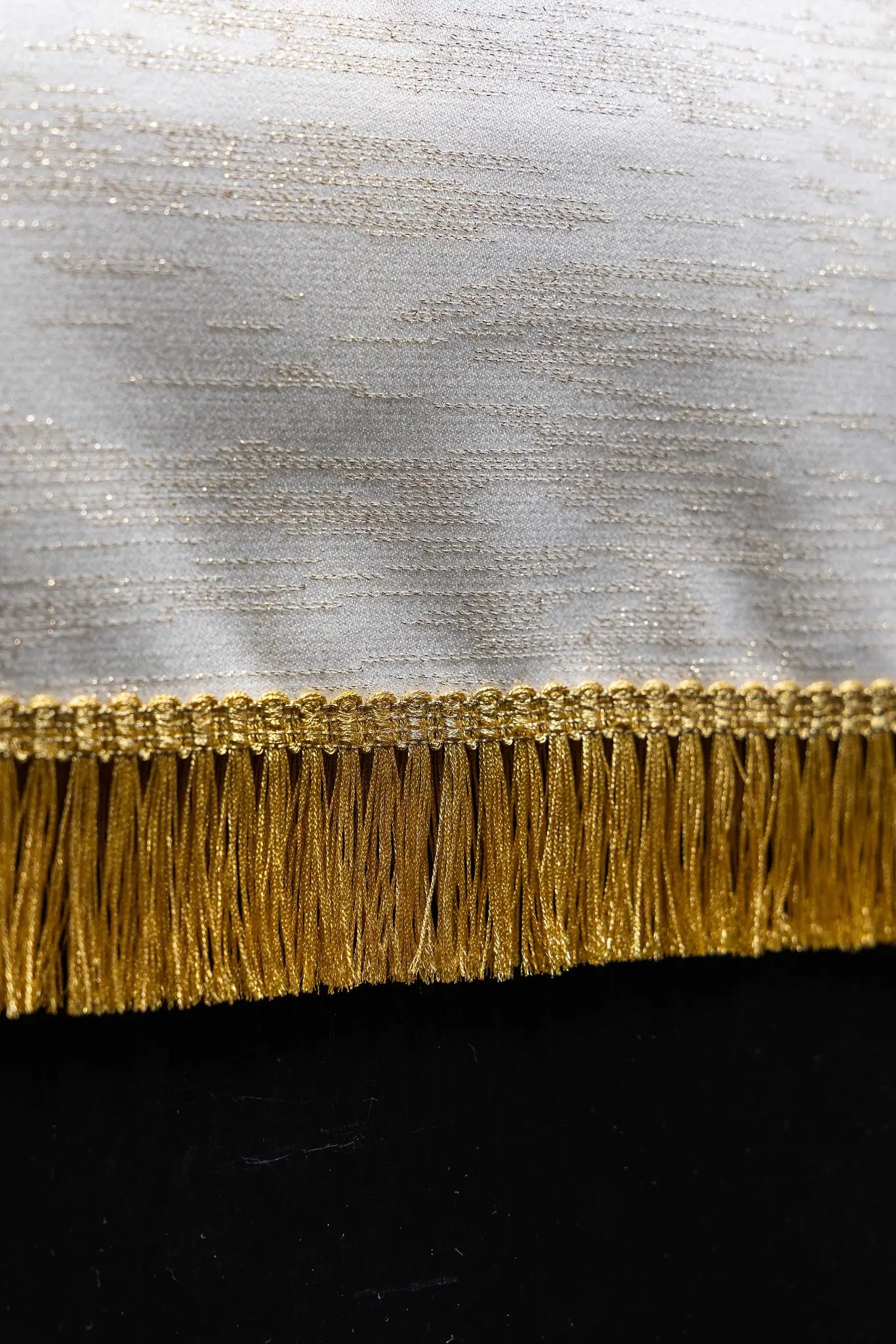 Ecru lectern cover with rich gold IHS monogram embroidery, radiant glory, wheat sheaves, and grapevines, finished with gold fringes.