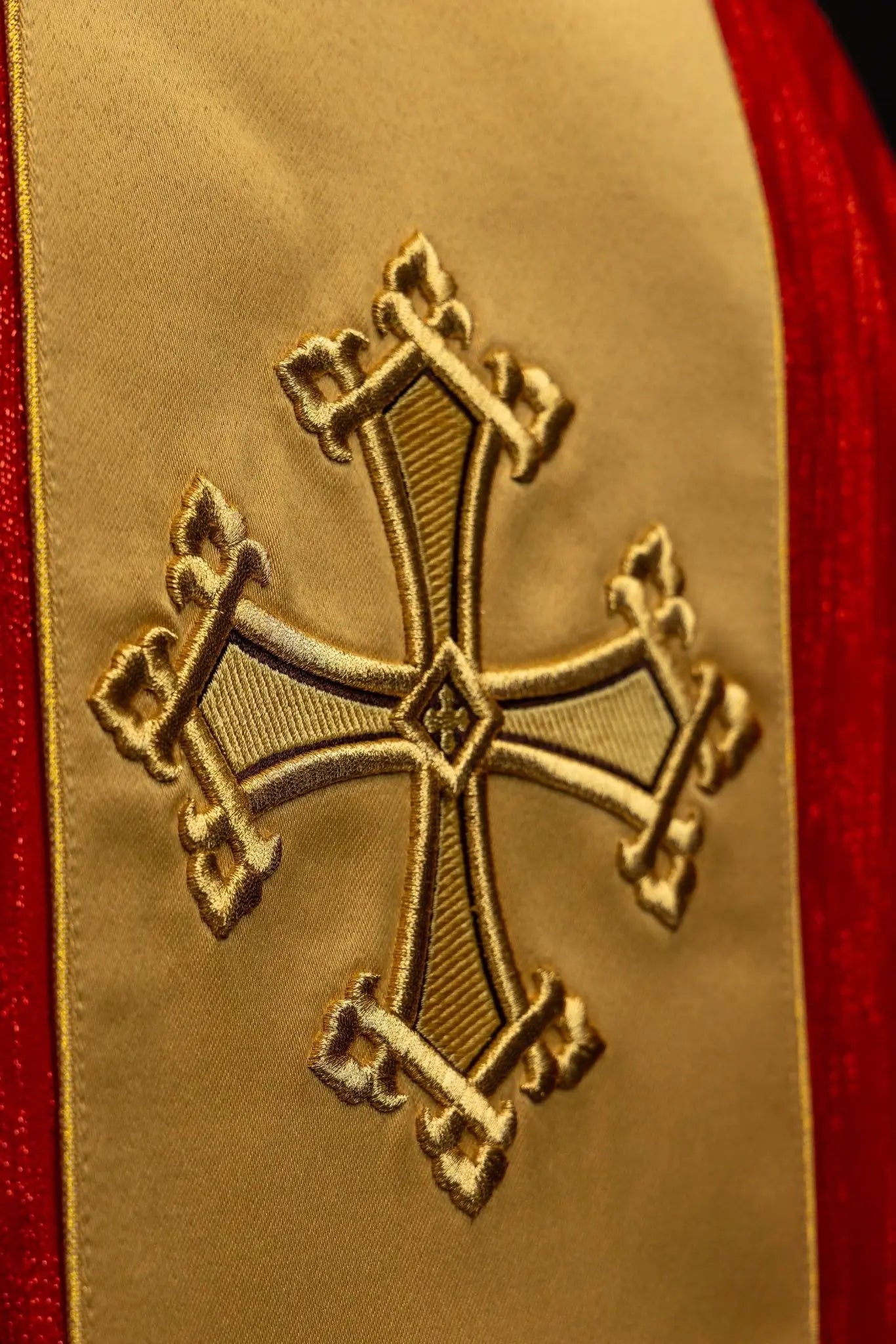 Red chasuble with embroidered cross motif and decorative gold band