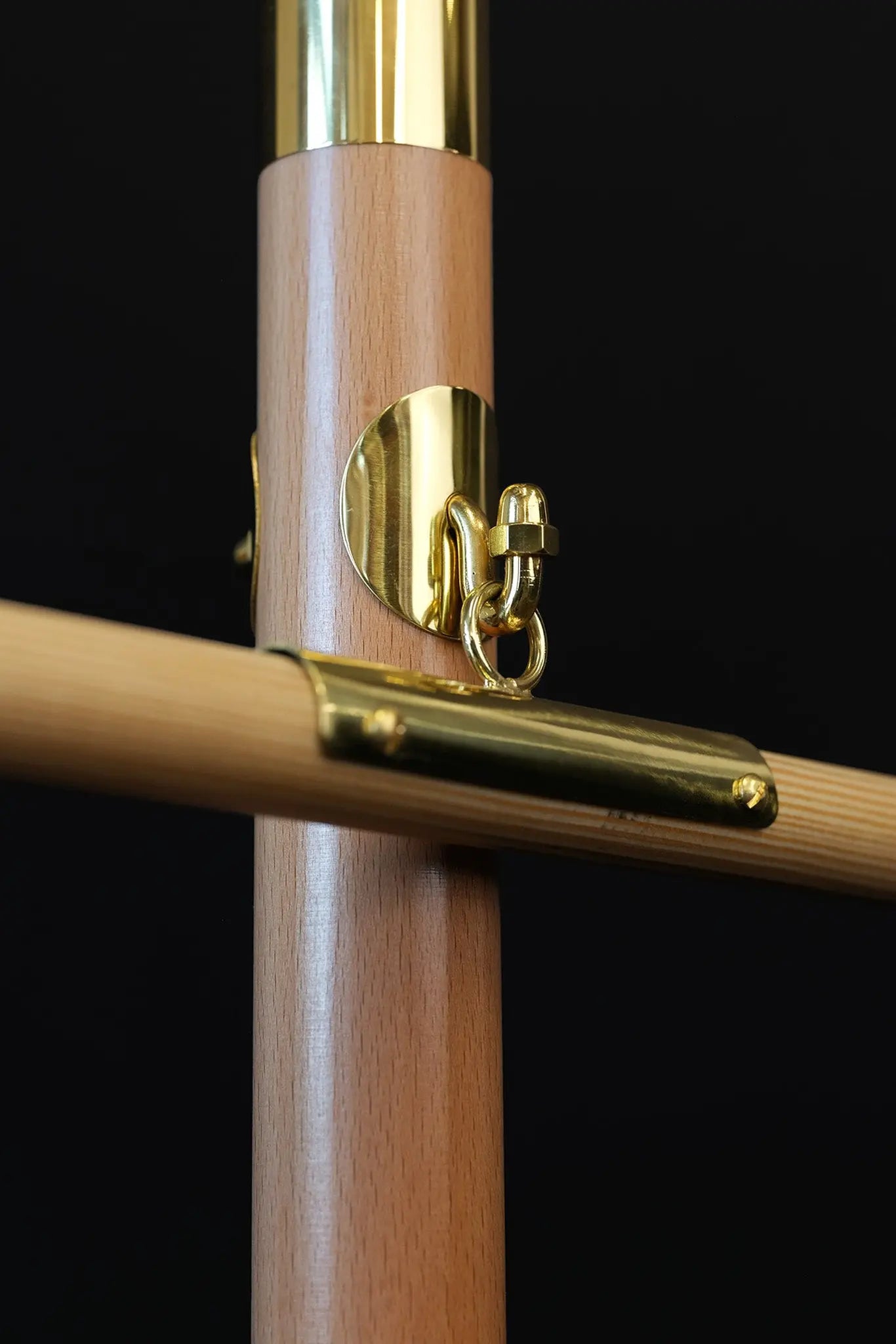 Light wood processional banner pole with decorative cross and gold metal accents