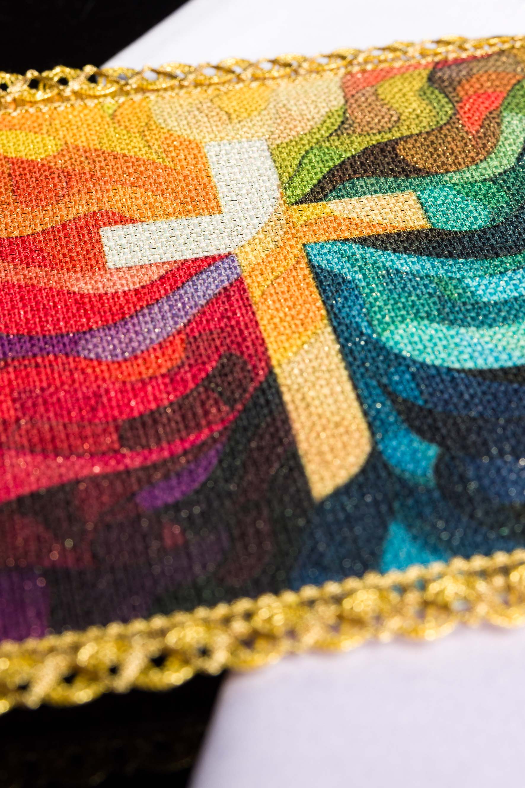 White lavabo towel with small embroidered gold cross, edged with delicate white trim