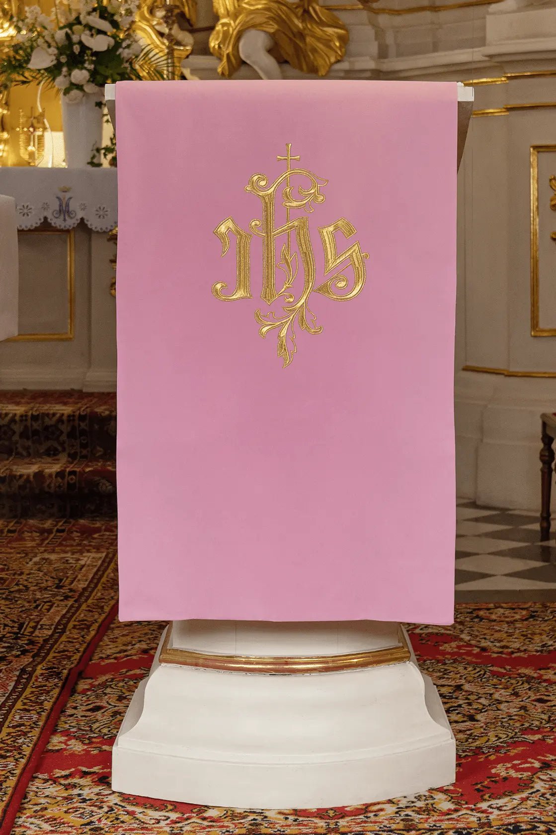 Pink lectionary napkin with the classic IHS symbol